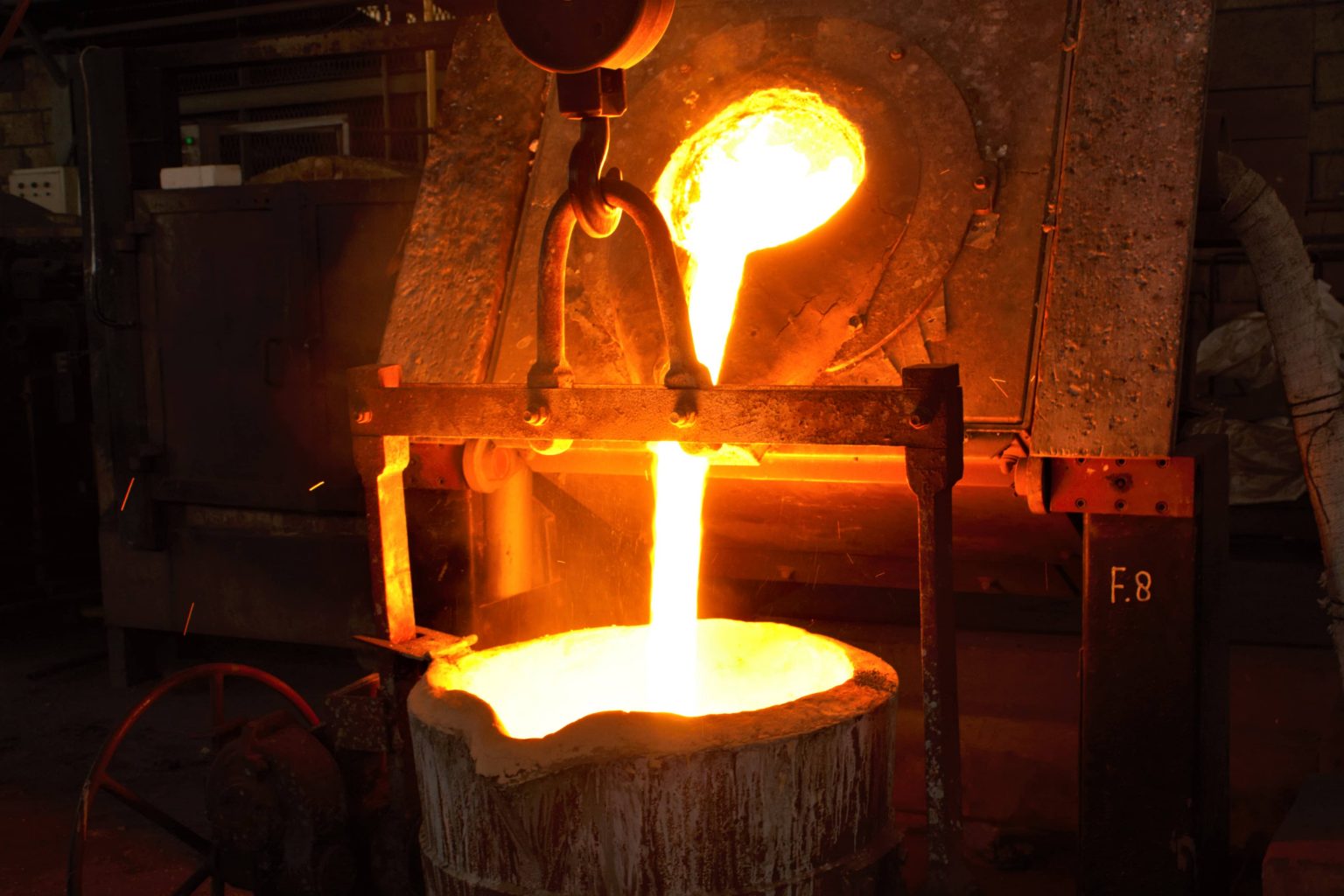 Molten stainless steel being poured from a ladle at the Trieka Aimex foundry