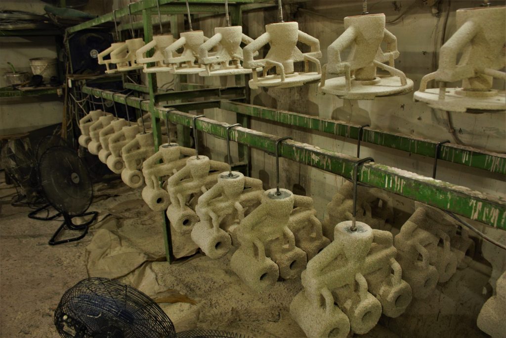 Investment casting shells drying on racks